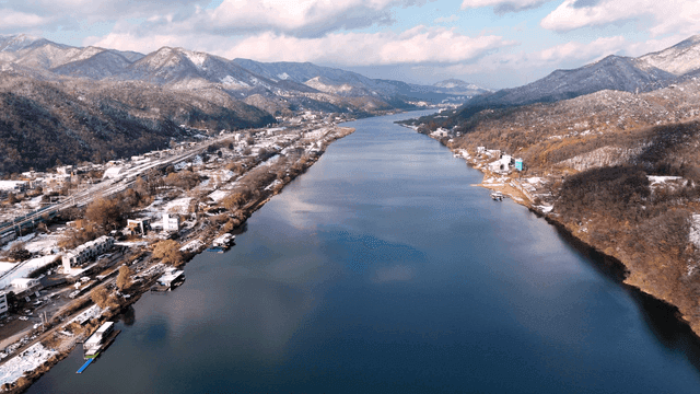 River flowing through snow-covered mountainous terrain