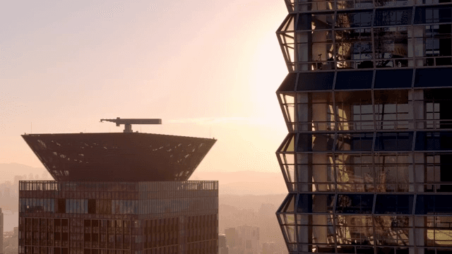 Modern skyscraper reflecting sunset