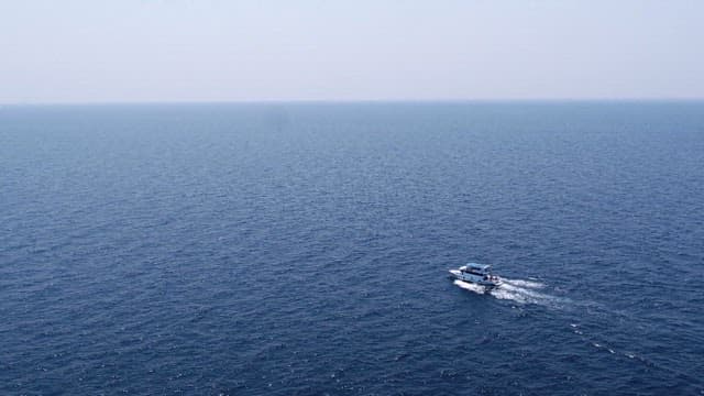 Boat sailing on the vast ocean