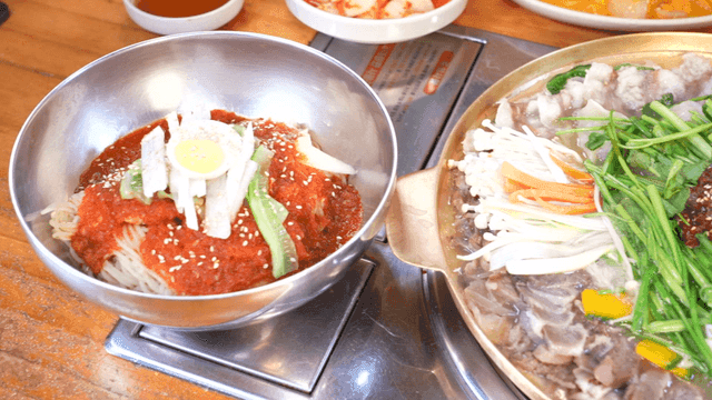 Stew and spicy bibim milmyeon on table