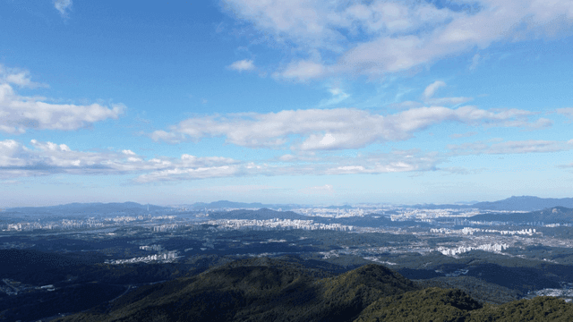 Vast city landscape with mountains in distance