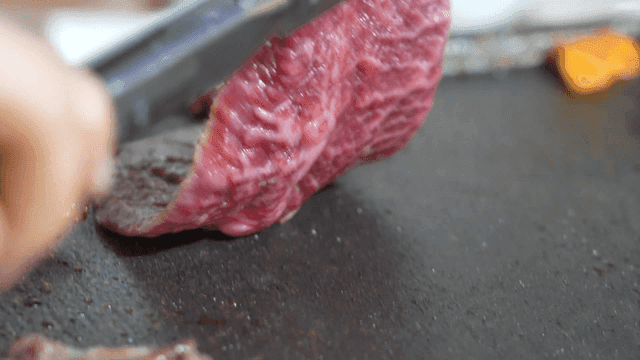 Fresh beef grilling on hot iron plate