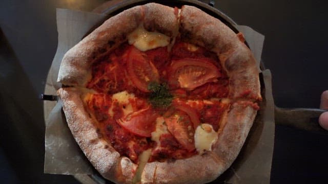 Pizza with fresh tomatoes and cheese in a restaurant