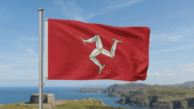 Red Isle of Man flag with unique pattern by sea