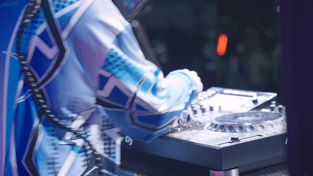 DJ performing with a mixer on stage