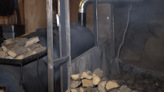 Wood being placed in a large furnace