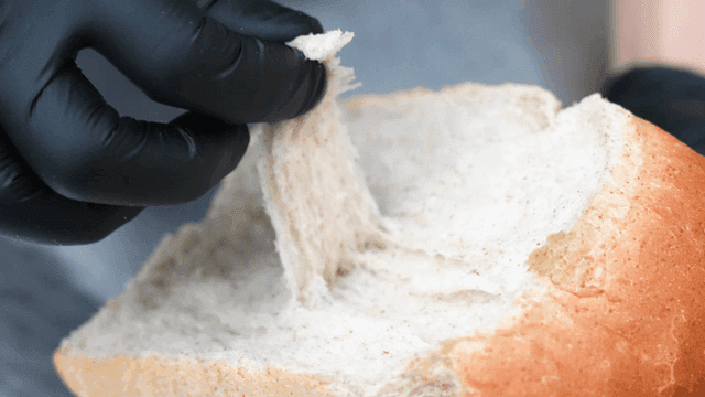 Person who tears grain of bread