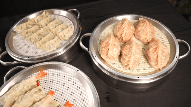 Various types of dumplings on steamers