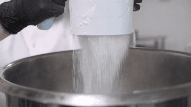 Pouring flour into a large mixing bowl