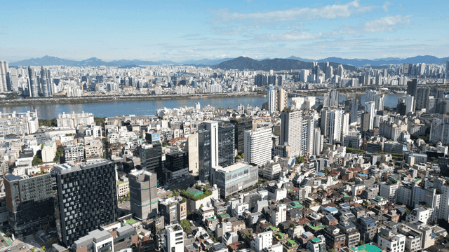 Urban skyline lined with riverside high-rises