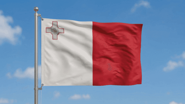 Flag of Republic of Malta fluttering against clear sky