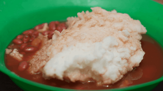 Bowl of African food with beans and mashed potatoes