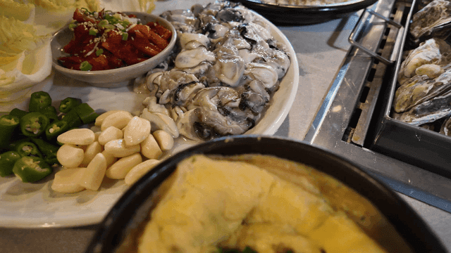 Table setting with raw oysters and side dishes
