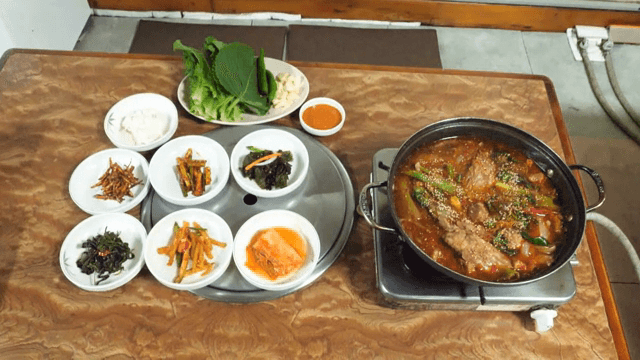 Spicy Braised Pork Galbi with side dishes on a table