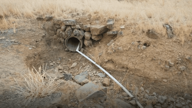 Dry landscape with rocks and a pipe
