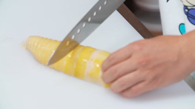 Slicing bamboo shoots on a cutting board