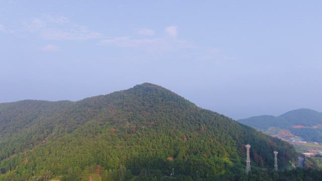 Lush green mountain under a clear sky