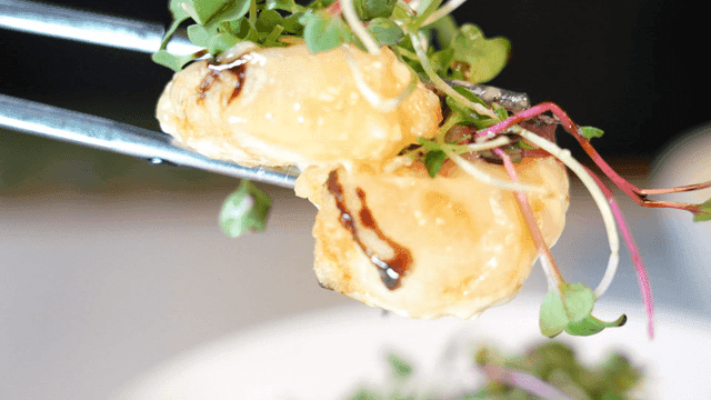 Creamy shrimp piled high with chopsticks and sprouts