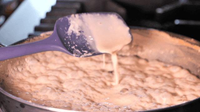 Spatula to stir cream sauce in pan