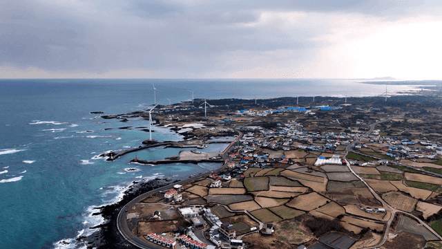 Coastal rural village with wind turbines