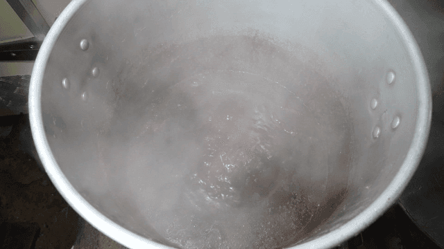 Soy sauce stock boiling in large pot