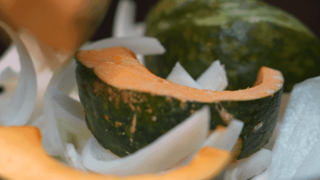 Sliced pumpkin and onions being prepared