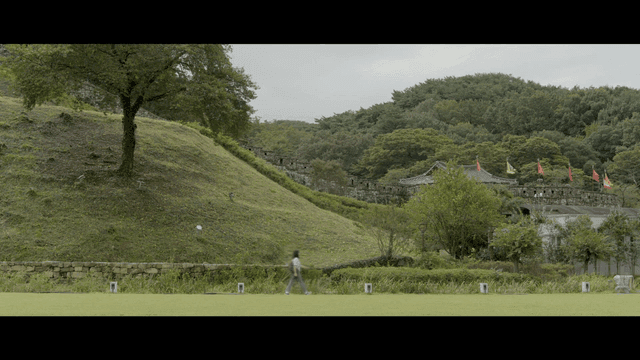 Woman walking near ancient fortress