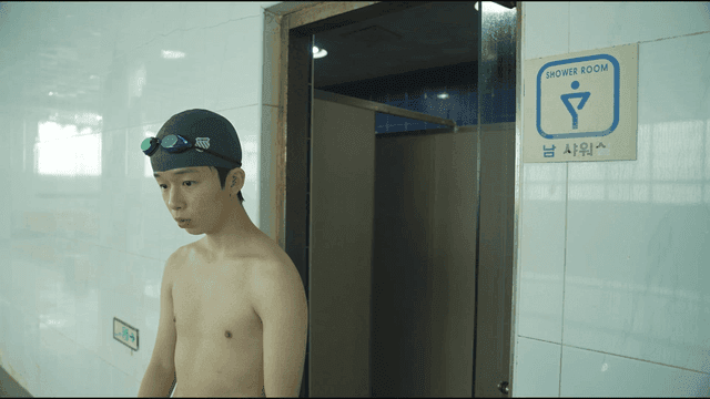 Man in swimsuit coming out of shower