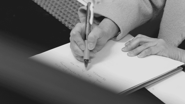 A person writing notes on a paper