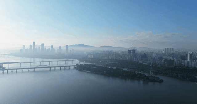 City skyline and bridges over river.