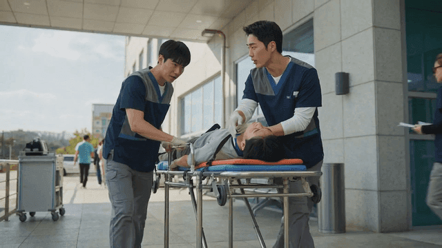 Medical staff transporting a patient on a stretcher outside a hospital