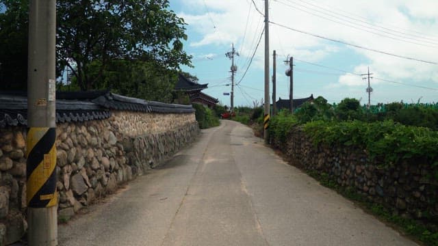 Quiet village road leading to traditional houses