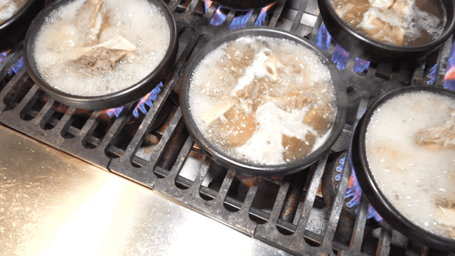 Beef short rib soup in earthenware pot boiling on stove