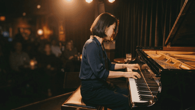Woman performing as pianist at cozy jazz club