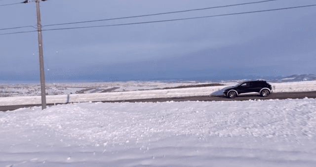 Snowy landscape with a car on the road