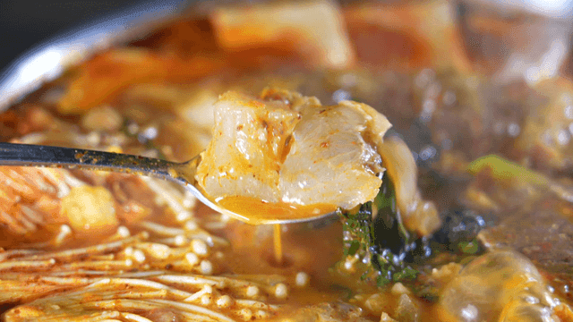 Beef tendons in spicy beef hot pot boiling in pot