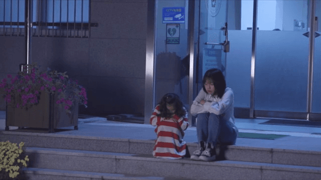 밤에 계단에 앉아 있는 두 사람