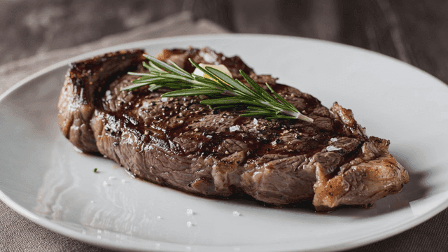 Grilled steak garnished with rosemary