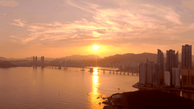 Sunset over a city skyline and bridge