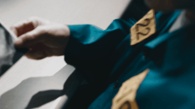 Prisoner looking at ultrasound image in interrogation room