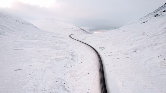 Winding road through snowy mountains