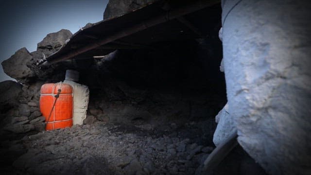 Small cave on the shore with a buoy visible