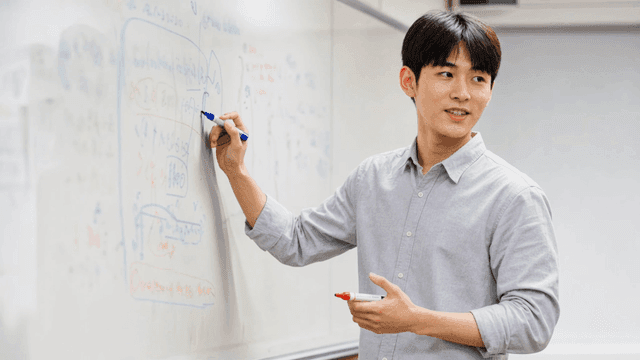Man giving lecture on whiteboard