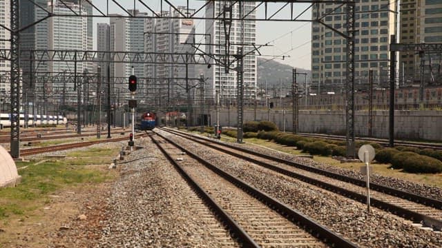 Train Approaching Through Urban Railway