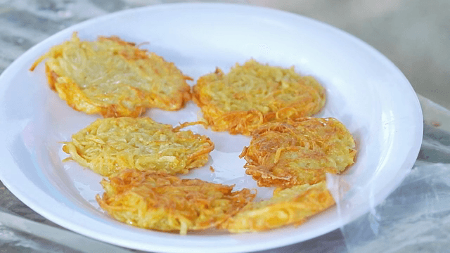 Golden potato pancakes on a white plate
