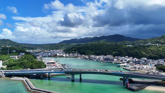 Coastal city with a bridge and mountains