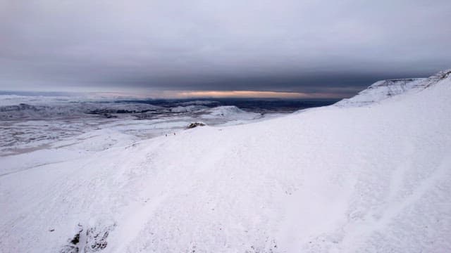 Snow-covered mountain landscape at dusk