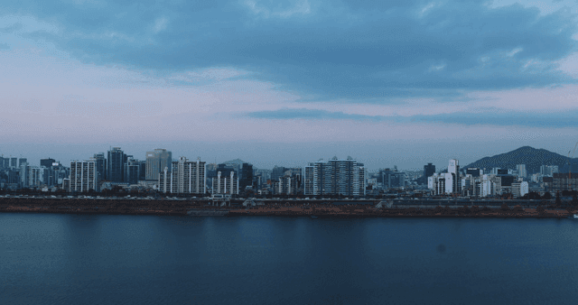 City skyline with a river at dusk