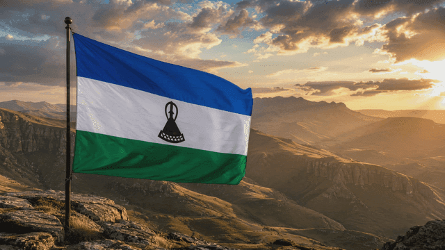 Mountain scenery with Kingdom of Lesotho flag at sunset