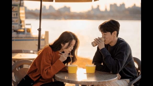 Couple eating Han River ramen by river